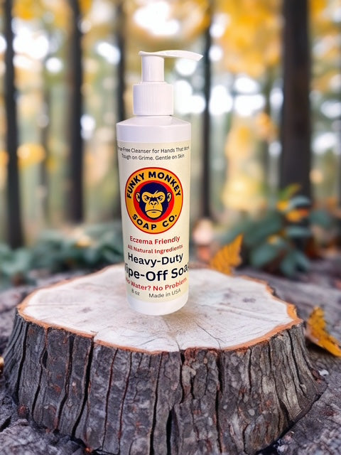 Funky Monkey Soap Co. bottle on a tree stump with a forest background
