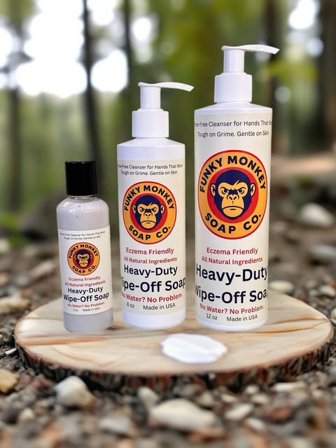Three bottles of Funky Monkey Soap Co. products on a wooden platform with a natural background.