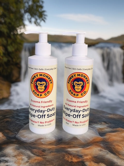 Two bottles of Funky Monkey Soap Co. soap on a rock with a natural background