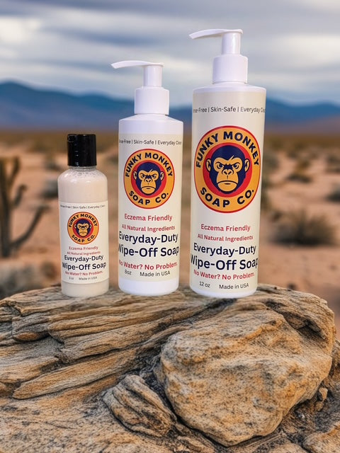 Three bottles of Funky Monkey Soap Co. soap on a rock with a desert landscape in the background