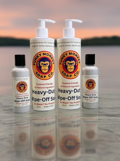 Funky Monkey Soap Co. products on a reflective surface with a blurred natural background